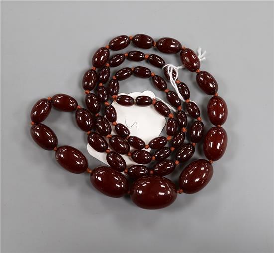 A single strand graduated simulated cherry amber necklace, gross weight 63 grams, 82cm.